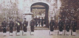 Soldiers of the Kumamoto Garrison with bayonet rifles (jūken) in front of the Kankaimon front gate of Shuri Castle. Following the Ryūkyū Shobun, the Kumamoto Garrison had been sent by the Meiji government and was lodged inside Shuri Castle.